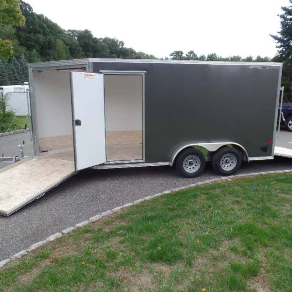 Two Place Enclosed Snowmobile Trailer, with Extra Height, will also carry a Side by Side, Aluminum Frame, Galvanized Axles, Finished Walls.