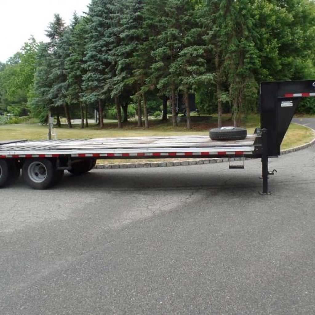 2022 Model Year 10 Ton Gooseneck Equipment Trailer, in like new condition. Has fold over Super Ramps, 10 Ton Payload Rated